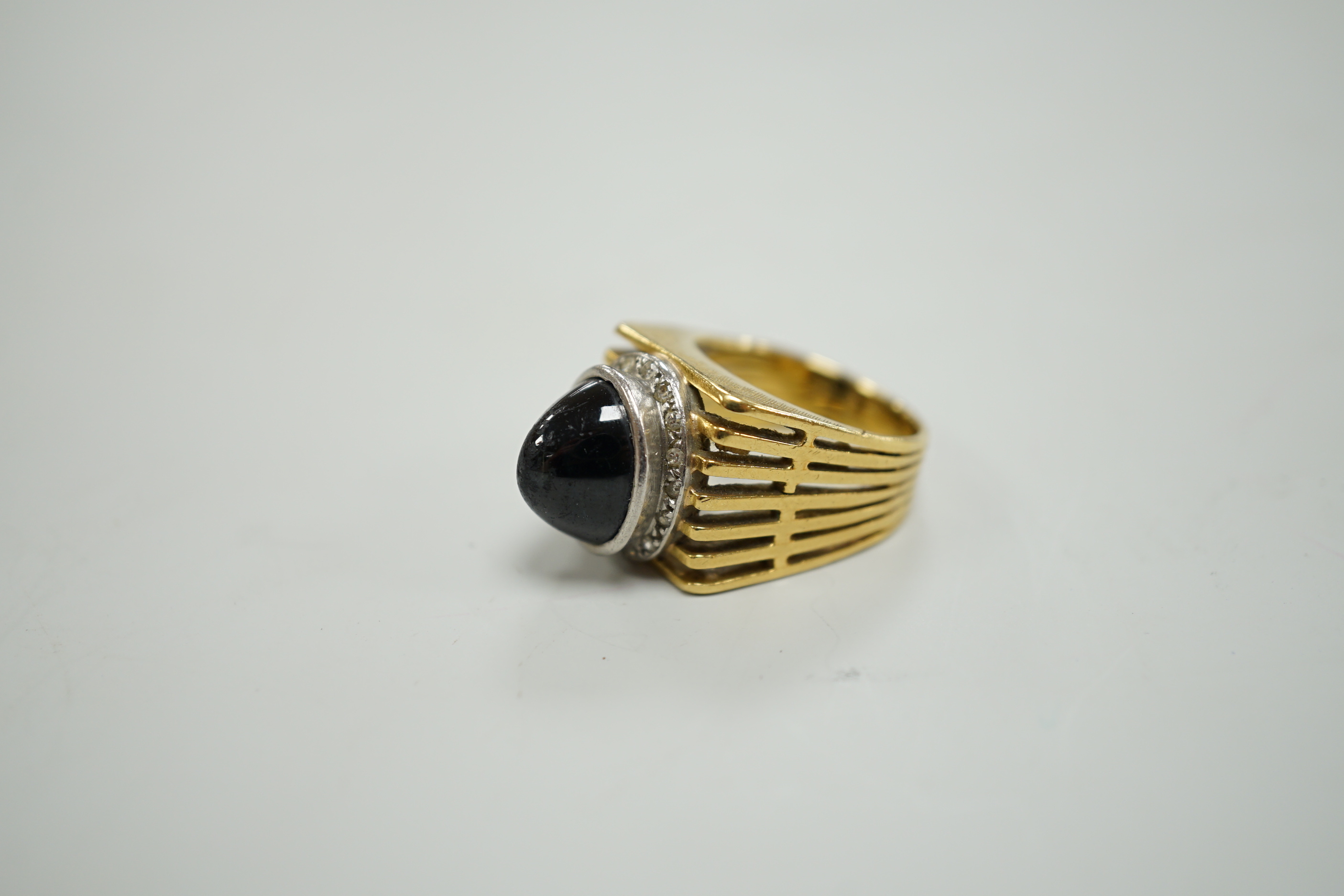 A pierced yellow metal, cabochon sapphire and diamond chip cluster set dress ring, size M, gross weight 13.4 grams.